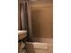 Bathroom showcasing modern tub with neutral tile surround and updated fixtures at 621 W 10Th St, Indianapolis, IN 46202