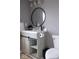 Bathroom featuring a vanity with modern fixtures, round mirror, and a toilet at 621 W 10Th St, Indianapolis, IN 46202