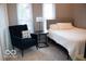 Cozy bedroom featuring a comfortable chair, side table, and a well-lit window at 621 W 10Th St, Indianapolis, IN 46202