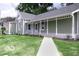 Charming single-story home showcasing a well-manicured lawn and inviting front porch at 621 W 10Th St, Indianapolis, IN 46202