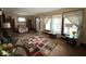 Bright living room featuring large windows and carpet flooring, creating a warm ambiance at 637 N Oakland Ave, Indianapolis, IN 46201
