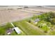 Aerial view of a beautiful home, driveway, and expansive green property surrounded by fields at 6629 N 600 W, Fairland, IN 46126