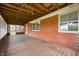 Spacious outdoor porch with a brick wall and wood floors providing a relaxing retreat at 6629 N 600 W, Fairland, IN 46126