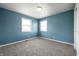 Calming blue bedroom with carpet, two windows for plenty of light, and white trim at 6629 N 600 W, Fairland, IN 46126