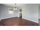 Bright dining room featuring hardwood floors, a modern chandelier, and a view to the kitchen at 6629 N 600 W, Fairland, IN 46126
