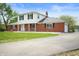 Charming two-story home featuring a well-maintained lawn, brickwork, and a driveway at 6629 N 600 W, Fairland, IN 46126