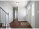 Bright foyer featuring wood floors, fresh paint, and a staircase leading to the upper level at 6629 N 600 W, Fairland, IN 46126