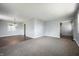 Open-concept living room with carpet flooring and a view into the dining area at 6629 N 600 W, Fairland, IN 46126