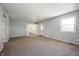 Open concept living room with access to kitchen and exterior door to yard at 6629 N 600 W, Fairland, IN 46126