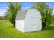 Outdoor storage shed in a yard with trees on a sunny day at 6629 N 600 W, Fairland, IN 46126