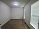 Bedroom with neutral walls, plush carpeting, and natural light from two windows at 7027 Pinnacle Dr, Columbus, IN 47201