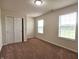 Neutral bedroom with two windows allowing natural light, carpet floors and closet space at 7027 Pinnacle Dr, Columbus, IN 47201