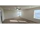 This bedroom is bright with carpet flooring, a ceiling fan, and multiple windows at 7027 Pinnacle Dr, Columbus, IN 47201