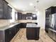 Modern kitchen features granite counters, stainless steel appliances, island, and dark wood cabinetry at 7027 Pinnacle Dr, Columbus, IN 47201