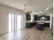 Open kitchen featuring dark cabinetry, stainless steel appliances, tiled floor and sliding door at 7027 Pinnacle Dr, Columbus, IN 47201