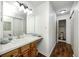 Bright bathroom with a vanity and sink, large mirror, lighting, and a separate toilet room at 7459 Quincy Ct, Indianapolis, IN 46254