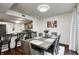 Bright dining area with wood table, seating for six, modern lighting, and open access to the kitchen at 7459 Quincy Ct, Indianapolis, IN 46254