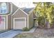 Charming two-story townhome with brown shingle siding and an attached one-car garage at 7459 Quincy Ct, Indianapolis, IN 46254