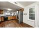 Well-lit kitchen with wooden cabinets, stainless steel refrigerator, and dining area view at 7459 Quincy Ct, Indianapolis, IN 46254