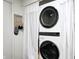 An LG brand stacked washer and dryer combo sit behind a white curtain at 7459 Quincy Ct, Indianapolis, IN 46254