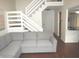 Inviting living room featuring a comfortable sectional sofa and staircase access at 7459 Quincy Ct, Indianapolis, IN 46254