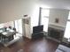 Bright and spacious living room featuring a fireplace, large windows, and dining area at 7459 Quincy Ct, Indianapolis, IN 46254