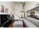 Open-concept living area with a two-story ceiling, staircase, and modern furnishings at 7459 Quincy Ct, Indianapolis, IN 46254