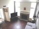 Sunlit living room featuring a cozy fireplace, tv, and expansive windows with natural light at 7459 Quincy Ct, Indianapolis, IN 46254