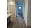 Bright hallway with wood floors leading to a white front door, adjacent to the kitchen at 780 James William Ln, Westfield, IN 46074