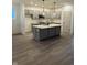 Modern kitchen featuring gray cabinets, a center island, and stainless steel appliances at 780 James William Ln, Westfield, IN 46074