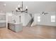Open-concept living area with modern furnishings, wood floors, neutral walls, and an elegant light fixture at 780 James William Ln, Westfield, IN 46074