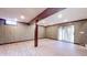 Finished basement with wood-paneled walls, neutral-toned flooring and a sliding door at 8937 W 800 N, Indianapolis, IN 46259