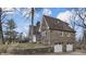 A charming stone home with a well-manicured lawn, featuring a chimney and multi-car garage at 8937 W 800 N, Indianapolis, IN 46259