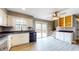 Open-concept kitchen with white cabinets, stainless steel appliances, and a door leading to a patio at 8937 W 800 N, Indianapolis, IN 46259