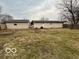 Large, grassy backyard with a detached garage and partially fenced perimeter at 1007 N 10Th St, Elwood, IN 46036