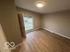 Bright bedroom features hardwood floors and natural light from a large window at 1007 N 10Th St, Elwood, IN 46036