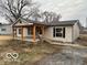 Inviting single-story home with a covered porch and neutral siding at 1007 N 10Th St, Elwood, IN 46036