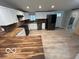 Updated kitchen with butcher block countertops, stainless steel appliances and white cabinets at 1007 N 10Th St, Elwood, IN 46036