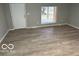 Bright living room featuring new floors and a large window for natural light at 1007 N 10Th St, Elwood, IN 46036