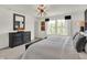 Bedroom with large bed, dresser, and neutral-colored carpet at 11611 Cotterill Way, Indianapolis, IN 46235