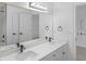 Bathroom features double sinks, modern hardware, and large mirror with hall access at 12878 Mayfair Ln, Carmel, IN 46032