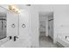 Bright bathroom featuring dual sinks, a modern glass shower, and a luxurious soaking tub at 12878 Mayfair Ln, Carmel, IN 46032