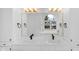 Elegant bathroom vanity with dual sinks, a large mirror, and bright lighting fixtures at 12878 Mayfair Ln, Carmel, IN 46032