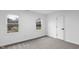 Bright bedroom with neutral walls, carpet, and two windows offering an outdoor view at 12878 Mayfair Ln, Carmel, IN 46032
