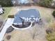 Aerial view of a luxurious two-story home with a well-manicured lawn, private driveway, and a glimpse of a pool at 12878 Mayfair Ln, Carmel, IN 46032