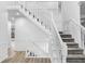 Staircase with neutral carpet and crisp, white trim, blending comfort and classic elegance at 12878 Mayfair Ln, Carmel, IN 46032