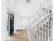 Grand foyer with a soaring ceiling, staircase with white banister, and elegant front door at 12878 Mayfair Ln, Carmel, IN 46032