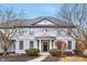 Stately two-story home boasts a welcoming entrance, with manicured bushes and a charming front balcony at 12878 Mayfair Ln, Carmel, IN 46032