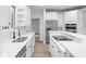 Bright kitchen with white cabinets, stainless steel appliances, and a center island with seating at 12878 Mayfair Ln, Carmel, IN 46032