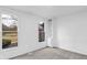 Bright, neutral living room showcasing built-in shelves and large windows for abundant natural light at 12878 Mayfair Ln, Carmel, IN 46032